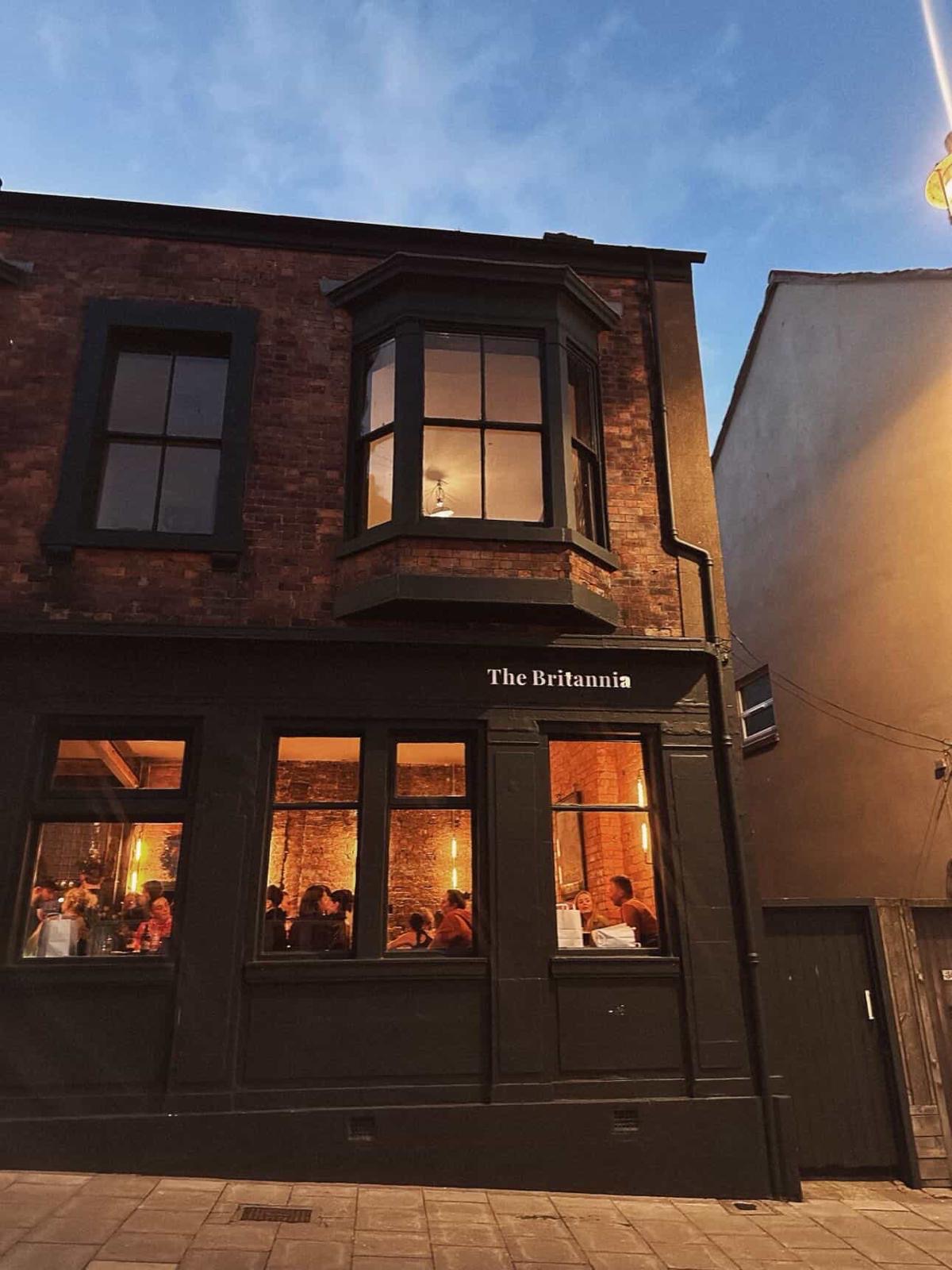 The Britannia from Eastborough at dusk, windows lit